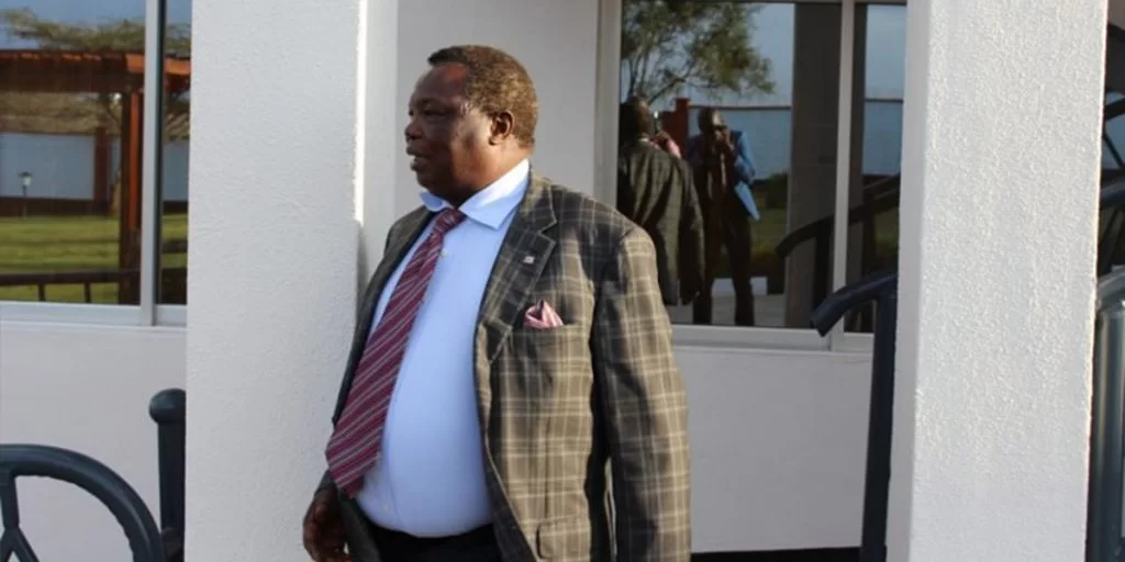 Atwoli standing outside his home