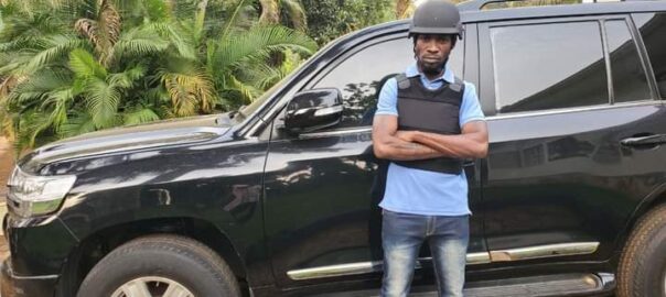 Bobi Wine next to his bulletproof car